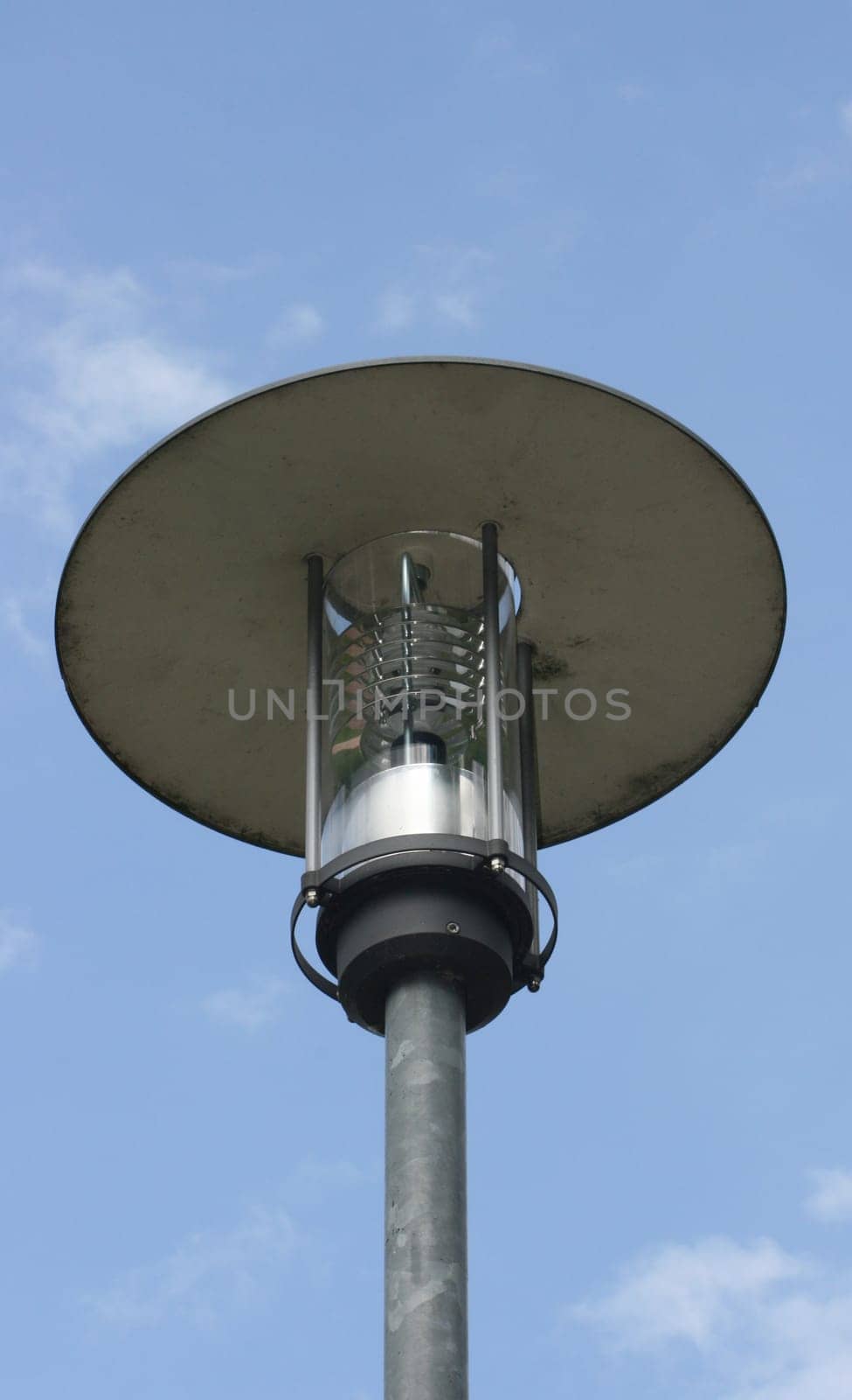 Street lamp with large umbrella,blue sky in the background