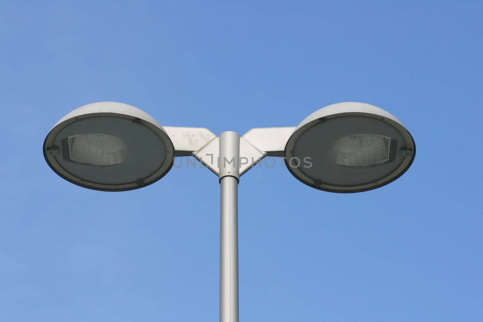 Street lamp with two spotlights,blue sky in the background