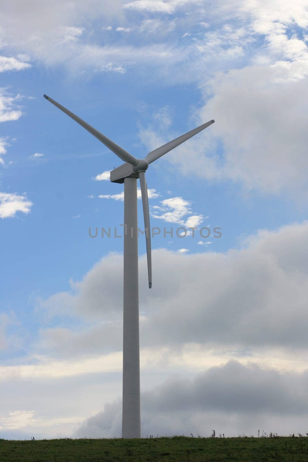 Wind turbine for power generation with blue sky in background