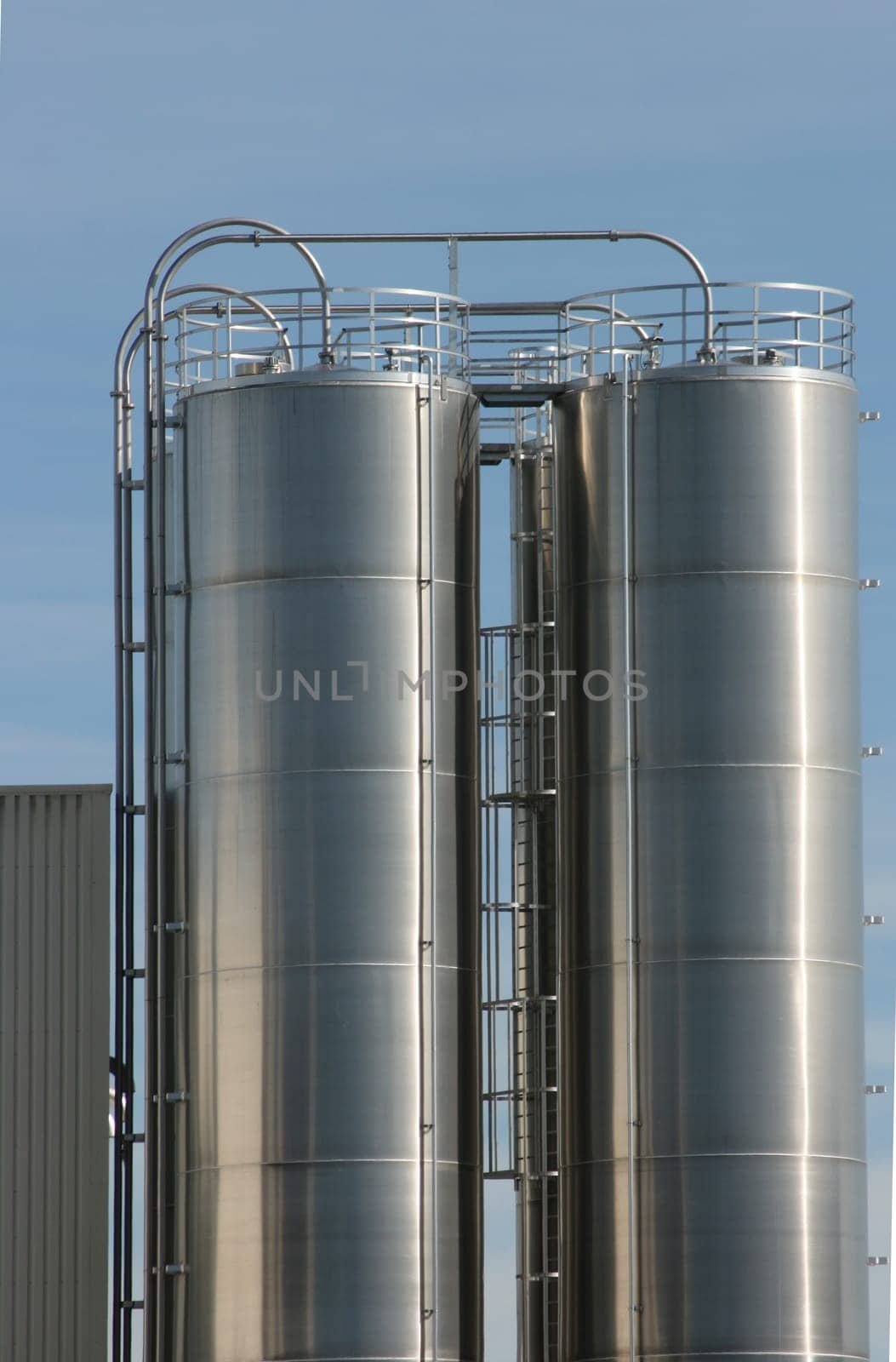 View of an industrial plant with large aluminium tanks