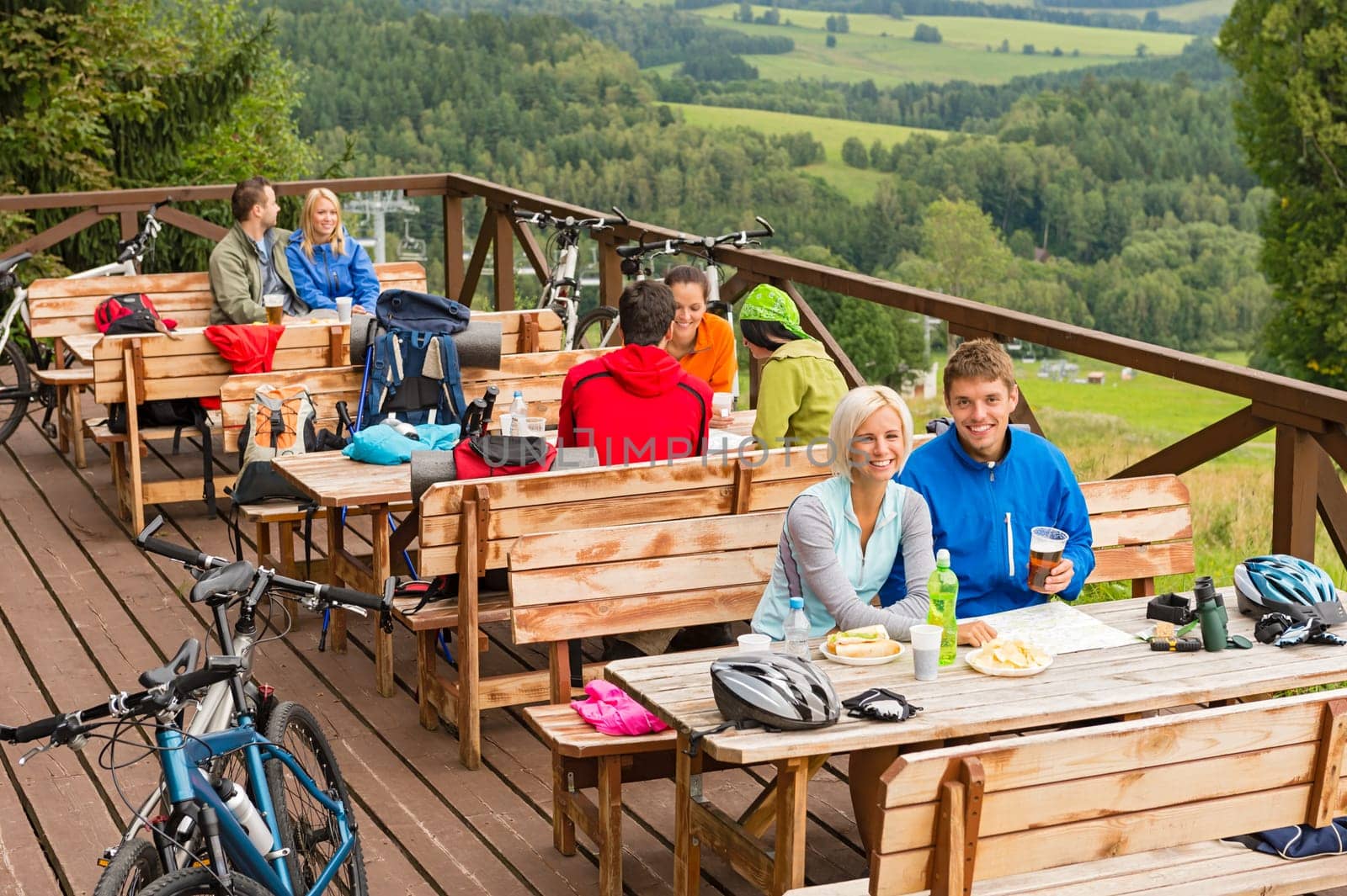 Young people relaxing looking at scenic mountain landscape  summer holiday