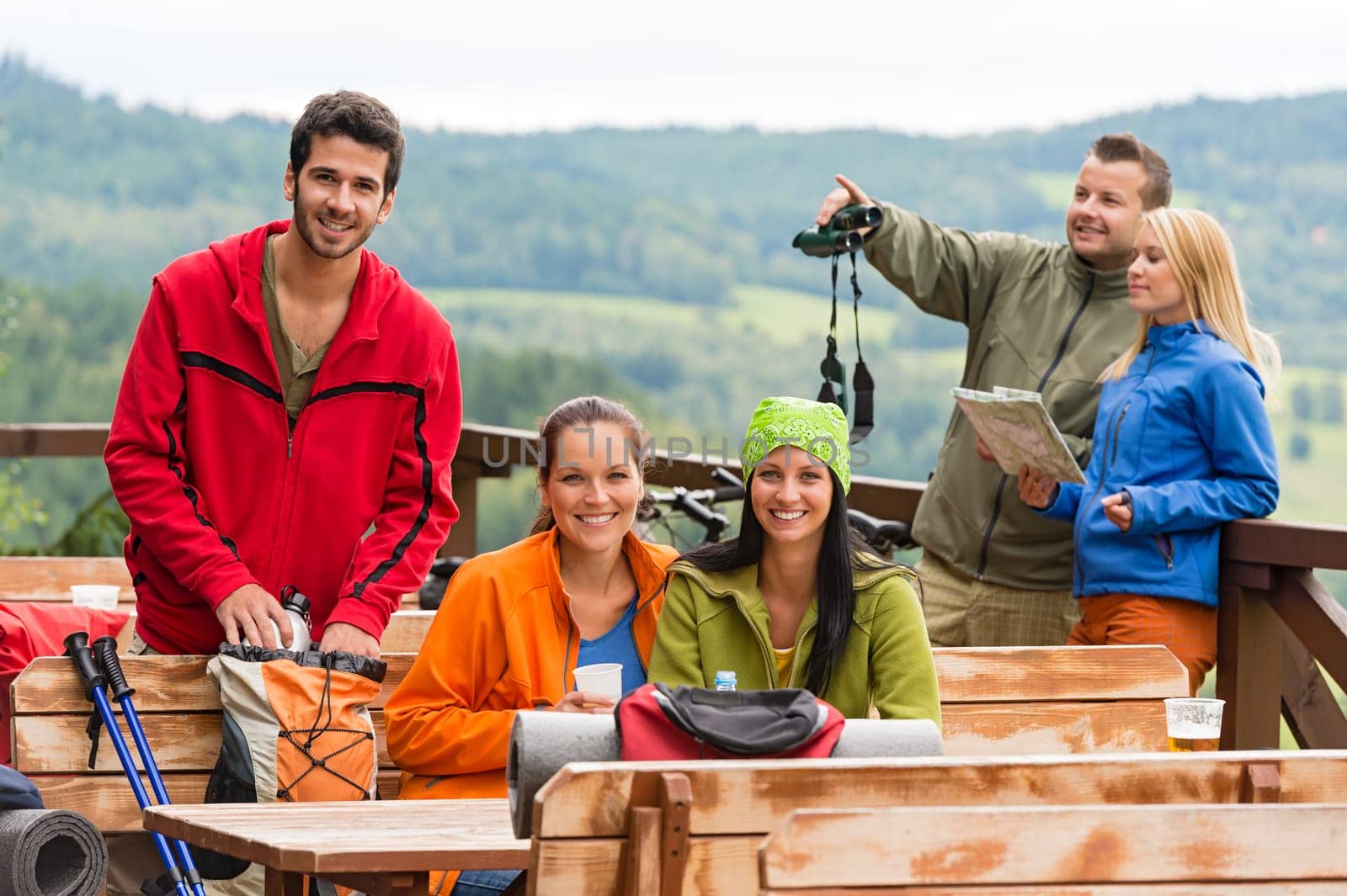 Young caucasian friends relaxing mountain countryside view summer sport