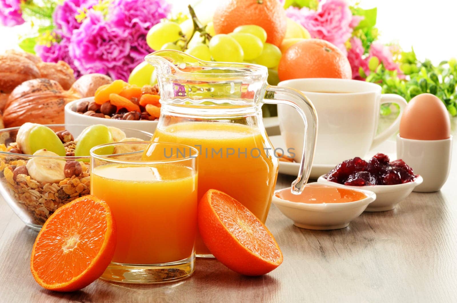 Breakfast including coffee, bread, honey, orange juice, muesli and fruits