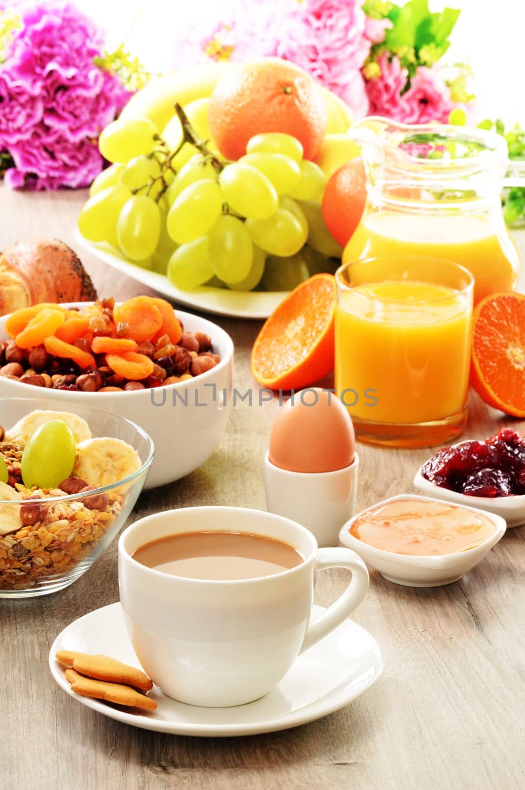 Breakfast including coffee, bread, honey, orange juice, muesli and fruits
