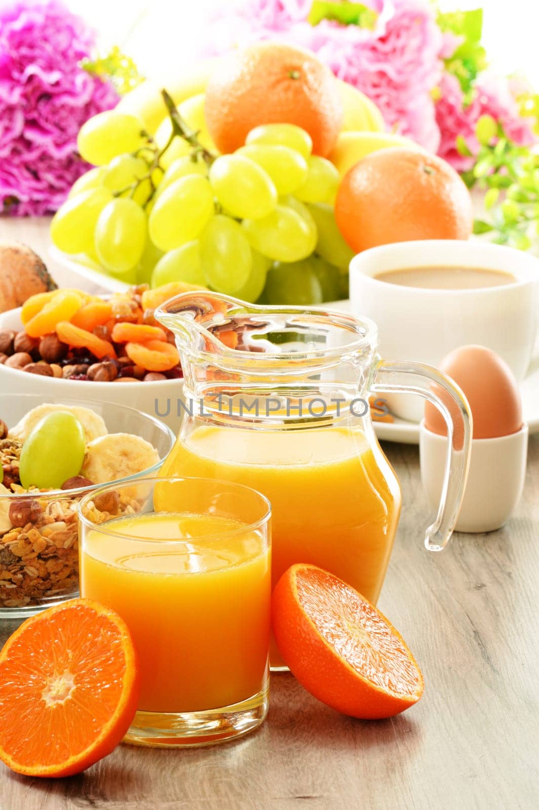 Breakfast including coffee, bread, honey, orange juice, muesli and fruits