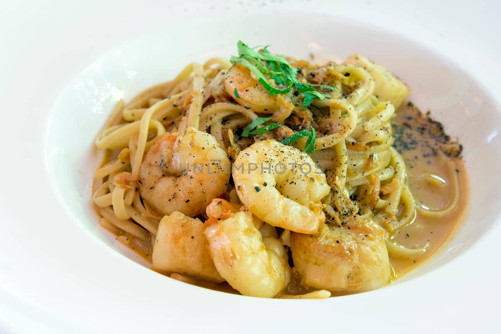 Linguini with Pan Seared Tiger Prawns and Scallops in a Bisque Cream Sauce Closeup