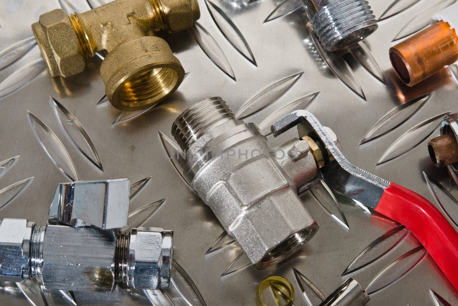 Plumbing inlet pipe valve on a metal surface