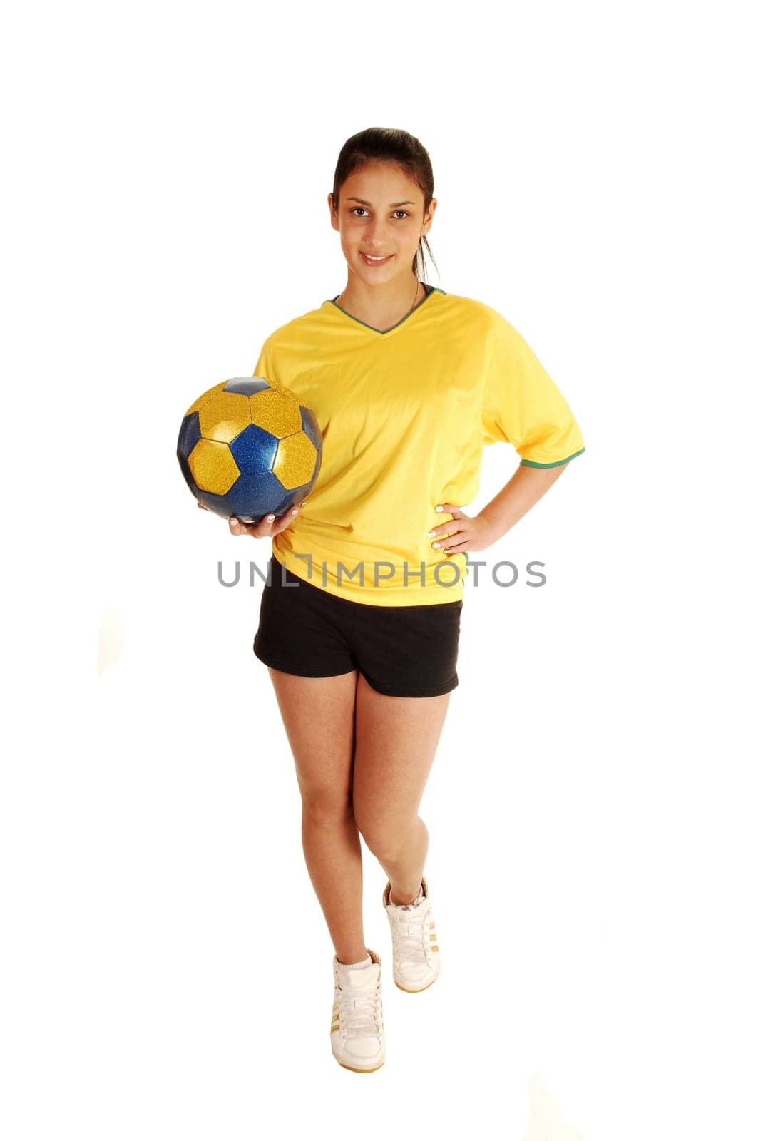 A teenage girl standing from the front, in a soccer uniform and holding the ball, with her long black hair in a ponytail for white background.