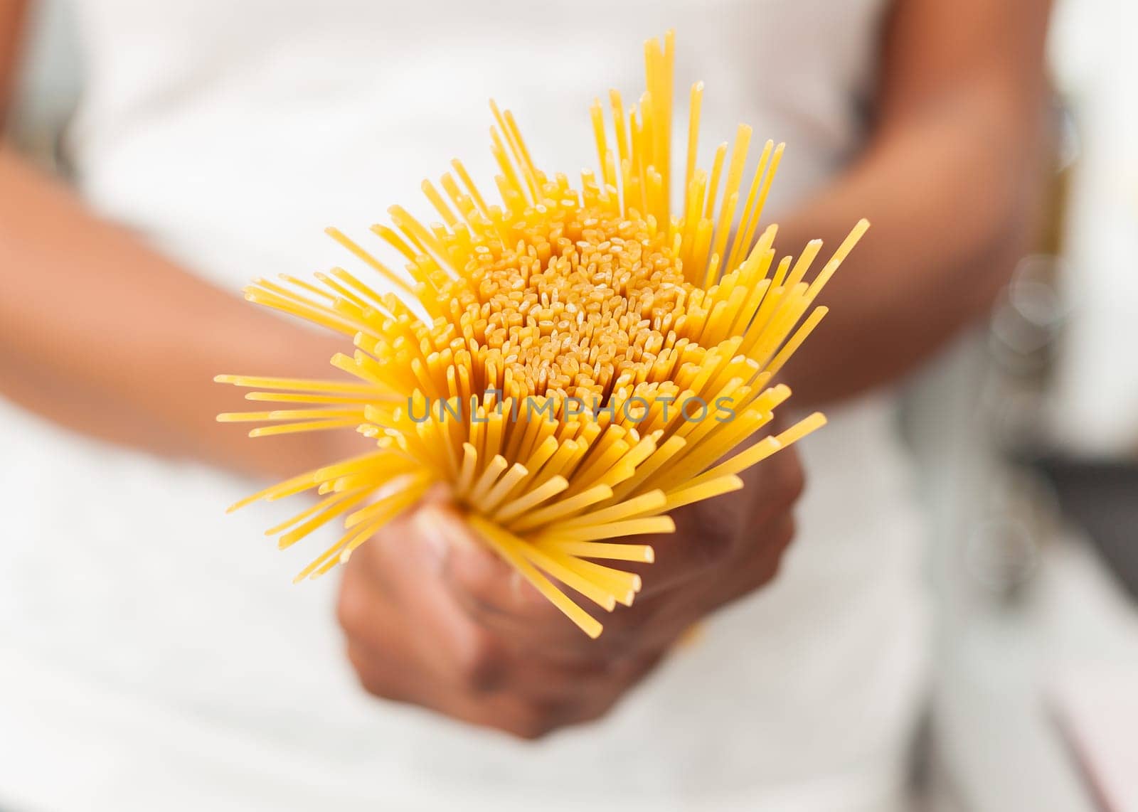 African American  woman  in the kitchen holding spaghetti