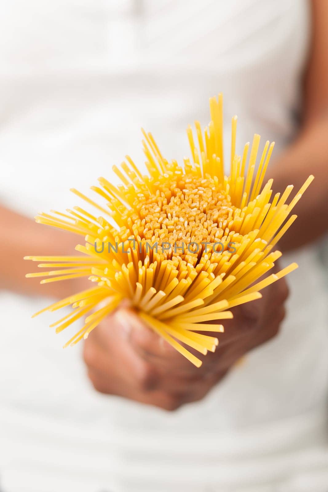 African American  woman  in the kitchen holding spaghetti