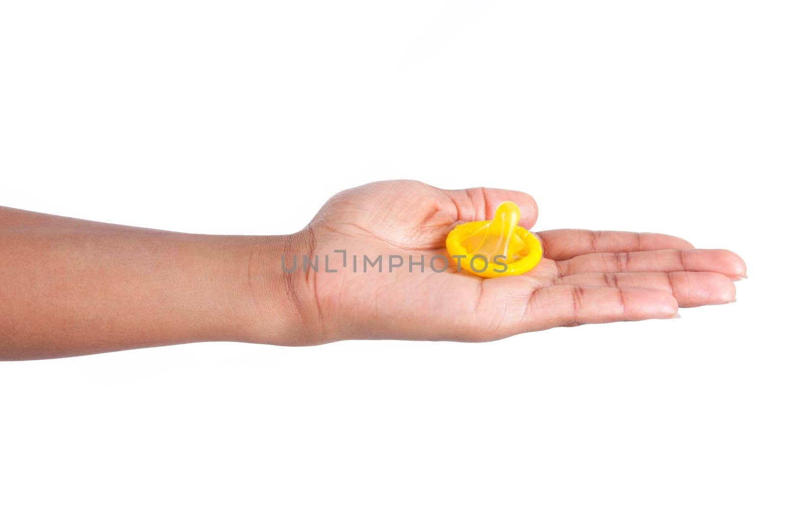 Safe sex concept. African woman Hand with condom, isolated on white background