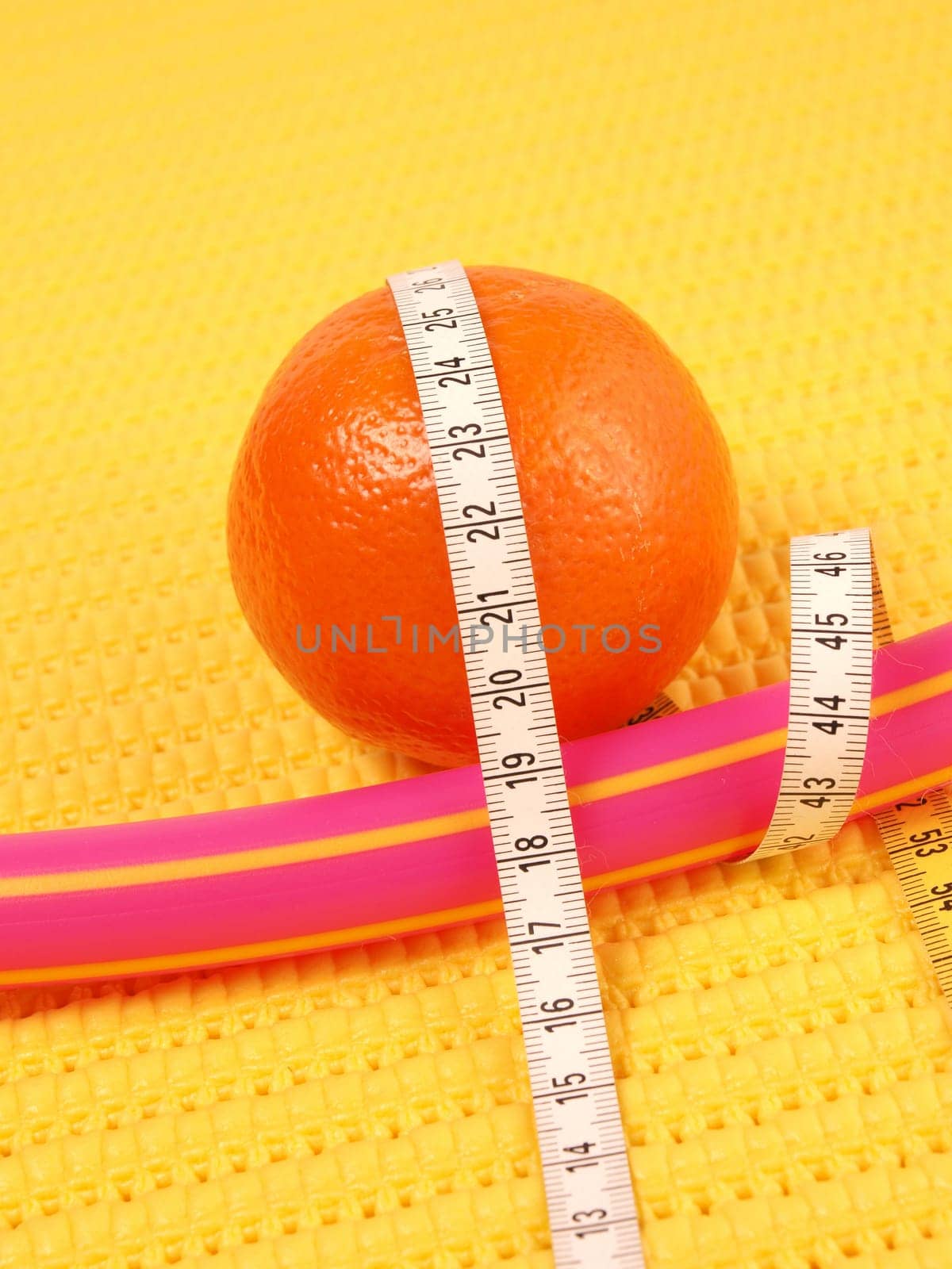 Tangerine with a measuring tape