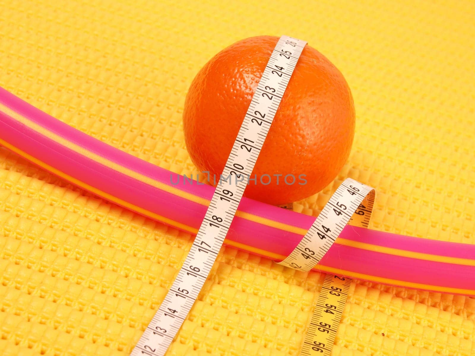Tangerine with a measuring tape