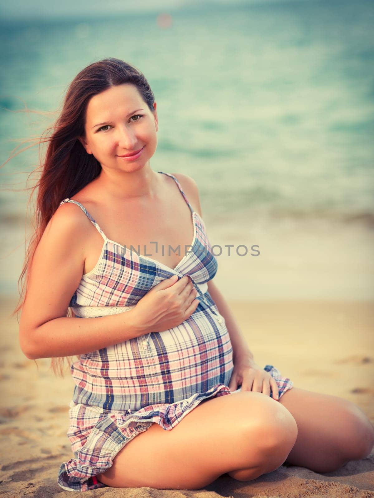 Beautiful pregnant woman on the beach