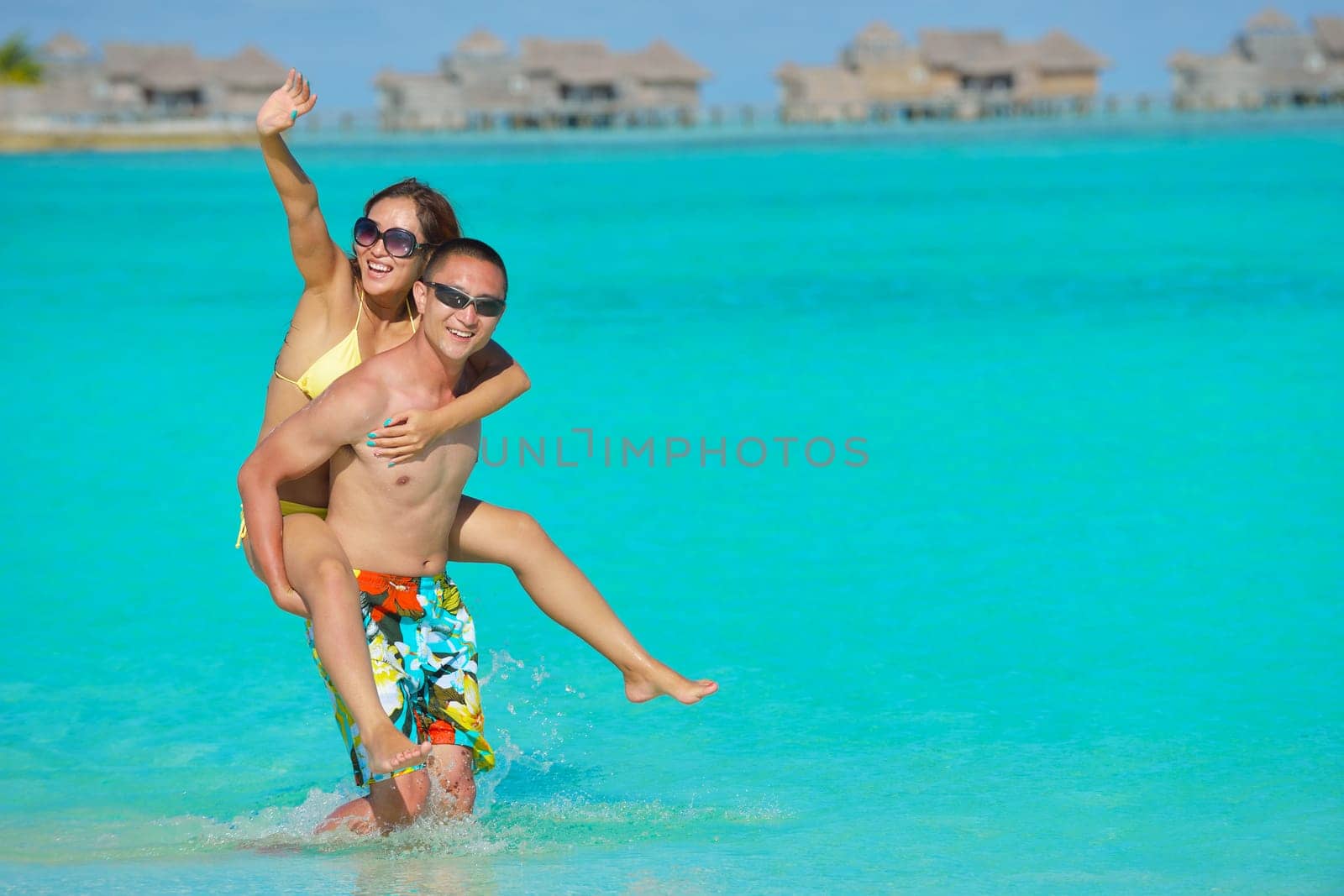 happy young asian couple have fun and romantic time at  summer on beautiful white sand beach