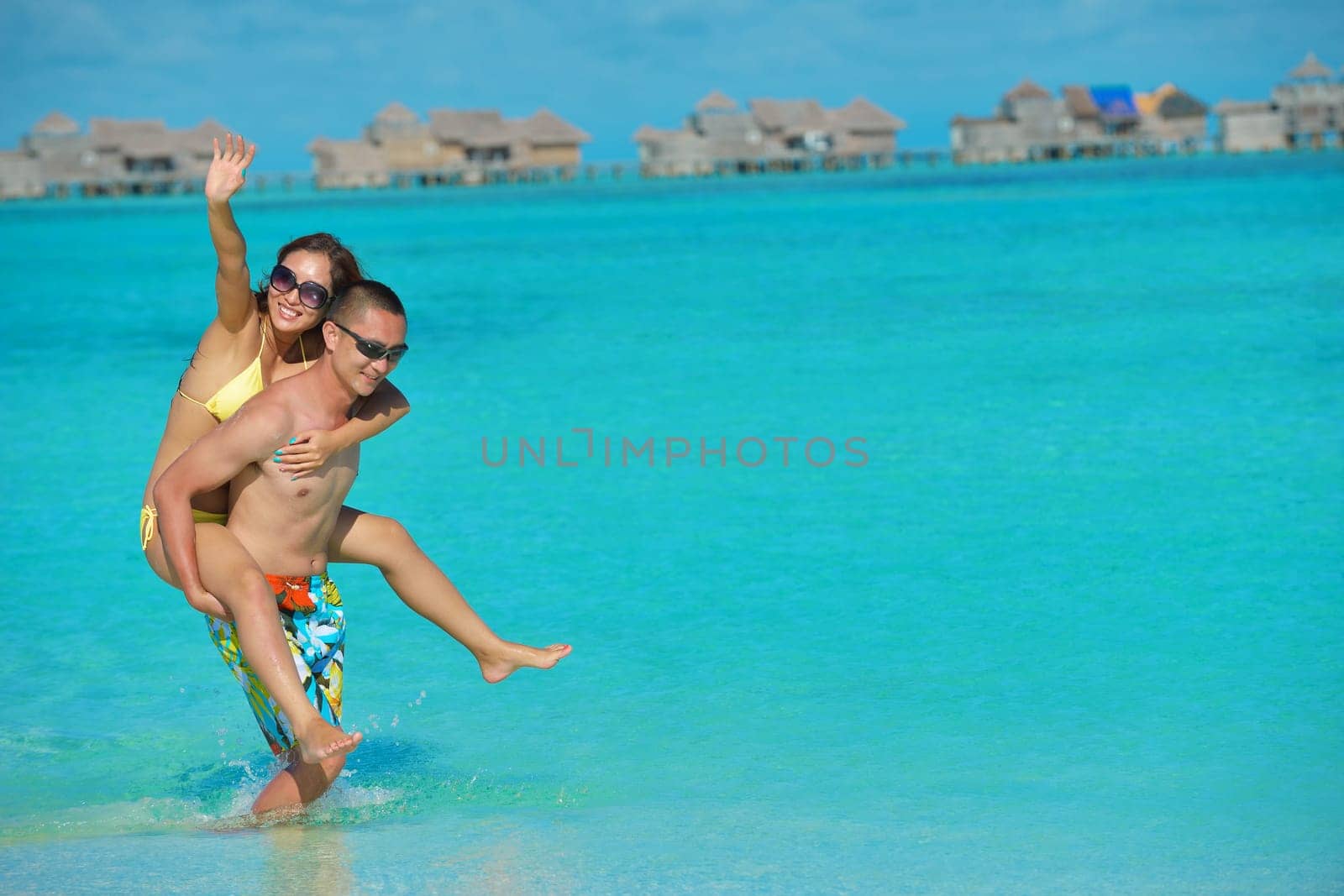 happy young asian couple have fun and romantic time at  summer on beautiful white sand beach