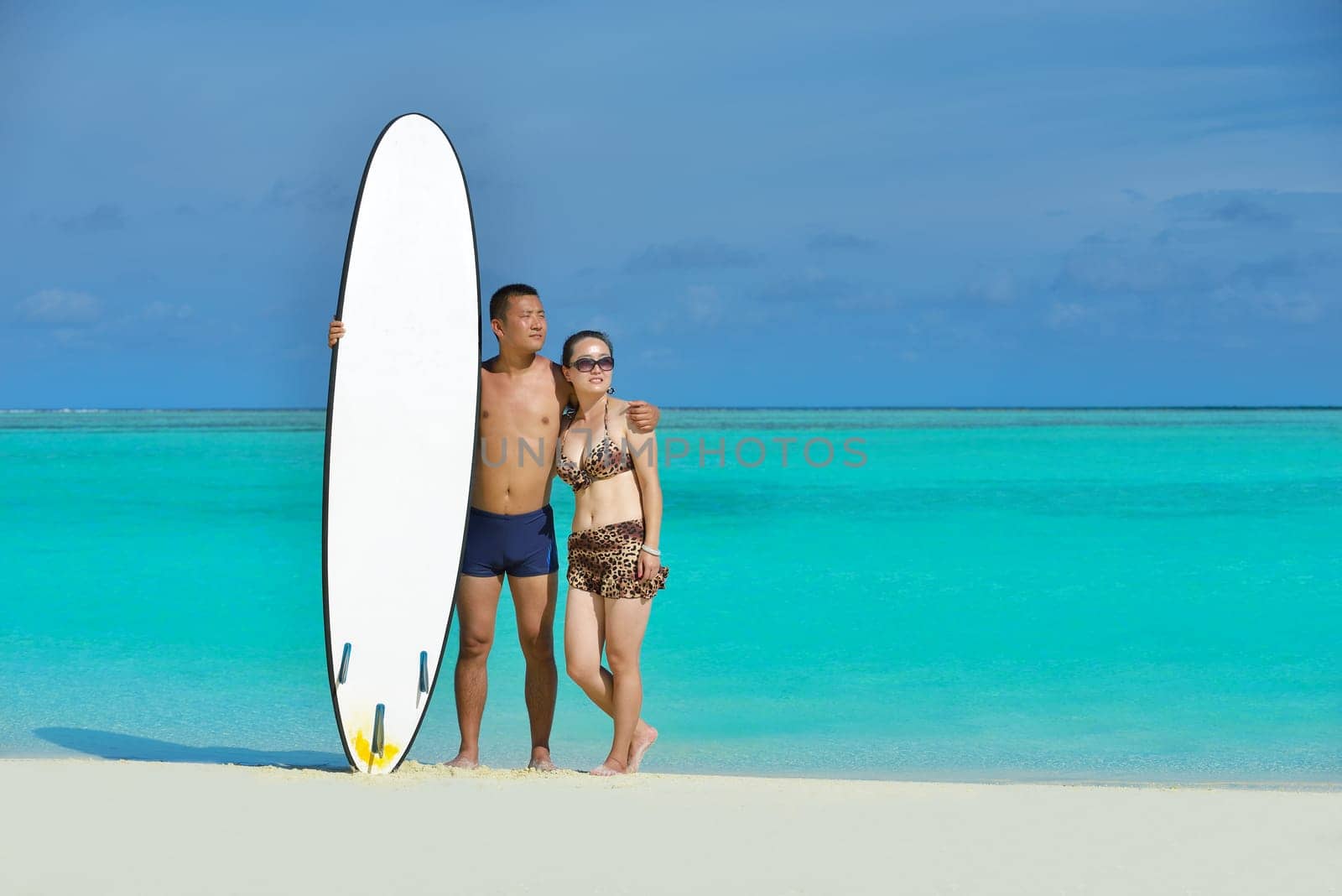 happy young asian couple have fun and romantic time at  summer on beautiful white sand beach