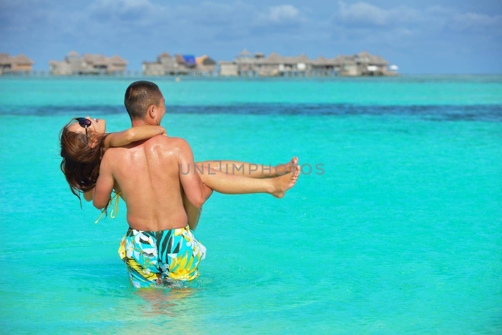 happy young asian couple have fun and romantic time at  summer on beautiful white sand beach