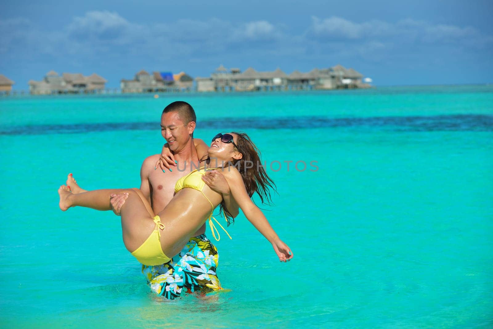 happy young asian couple have fun and romantic time at  summer on beautiful white sand beach