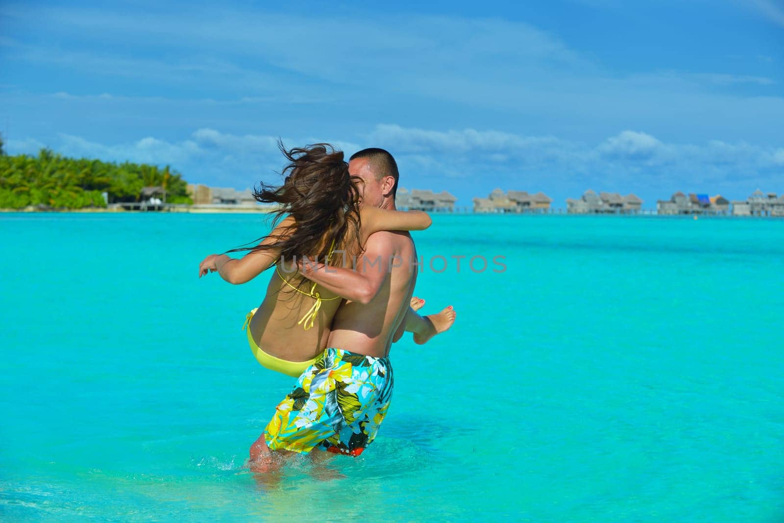 happy young asian couple have fun and romantic time at  summer on beautiful white sand beach