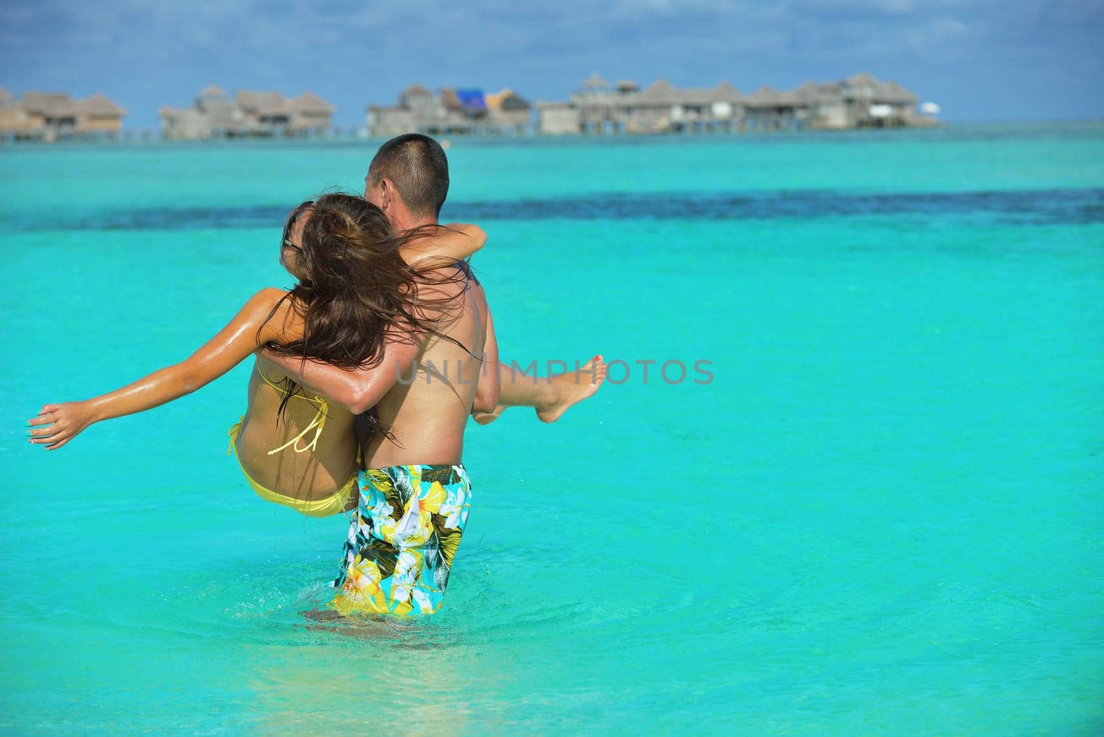 happy young asian couple have fun and romantic time at  summer on beautiful white sand beach