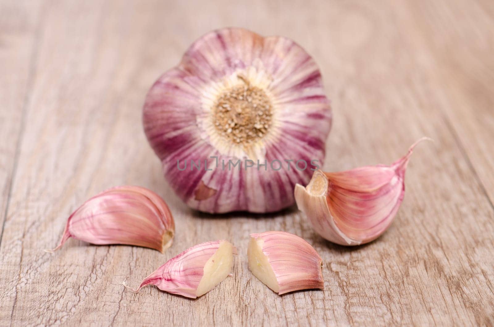 Raw garlic on an old wooden board