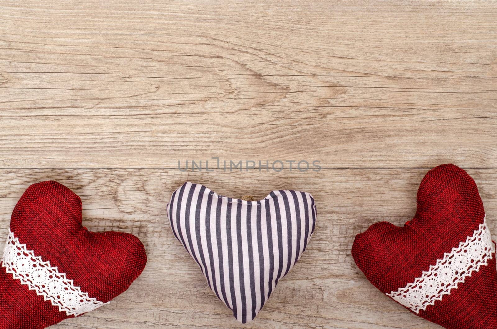 Card for Valentine's Day with three hearts made of fabric