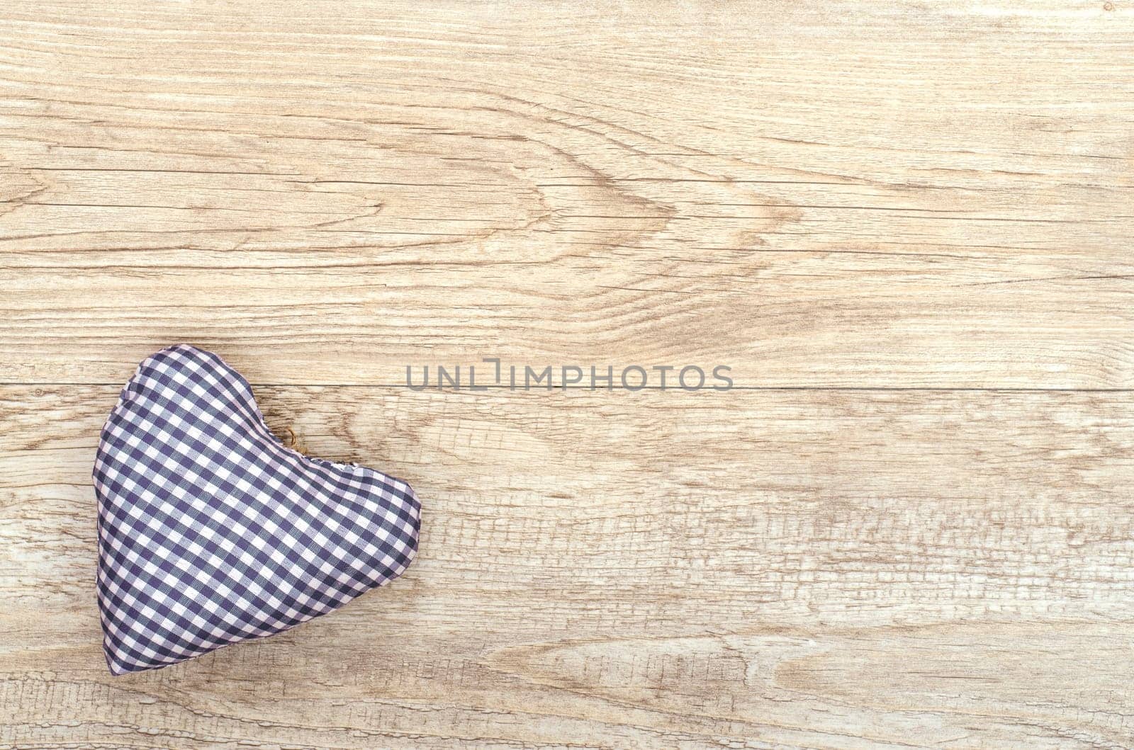 Fabric heart blue checkered on old wood