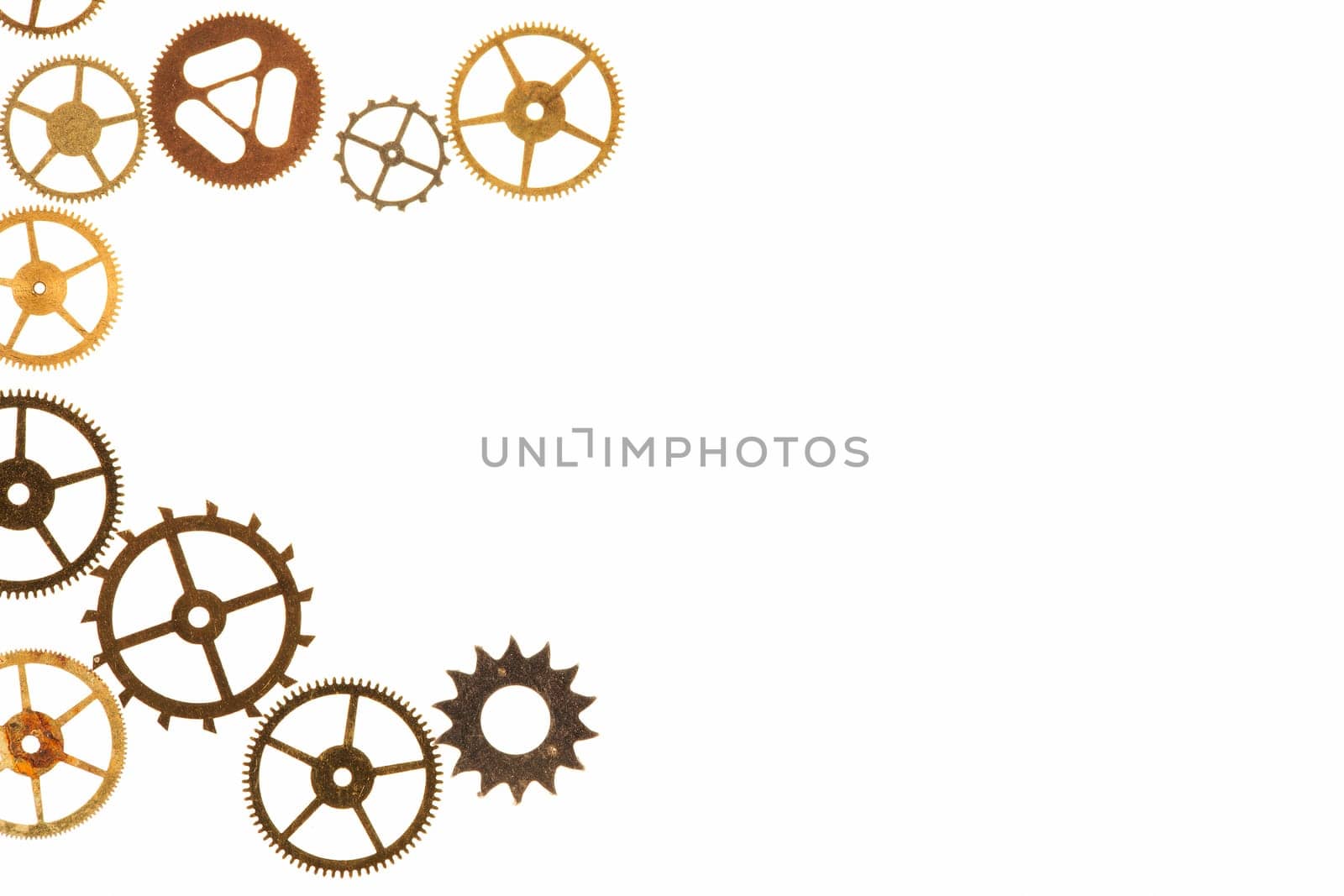 Cogs and other watch parts isolated on white background with copy space.