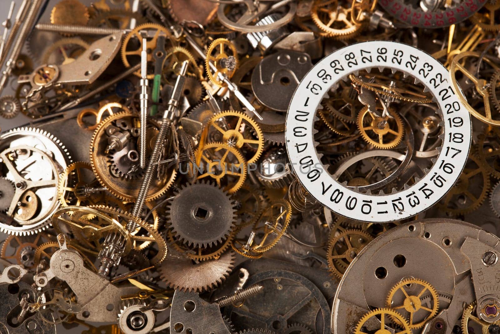 Pile of watch parts with date ring on top