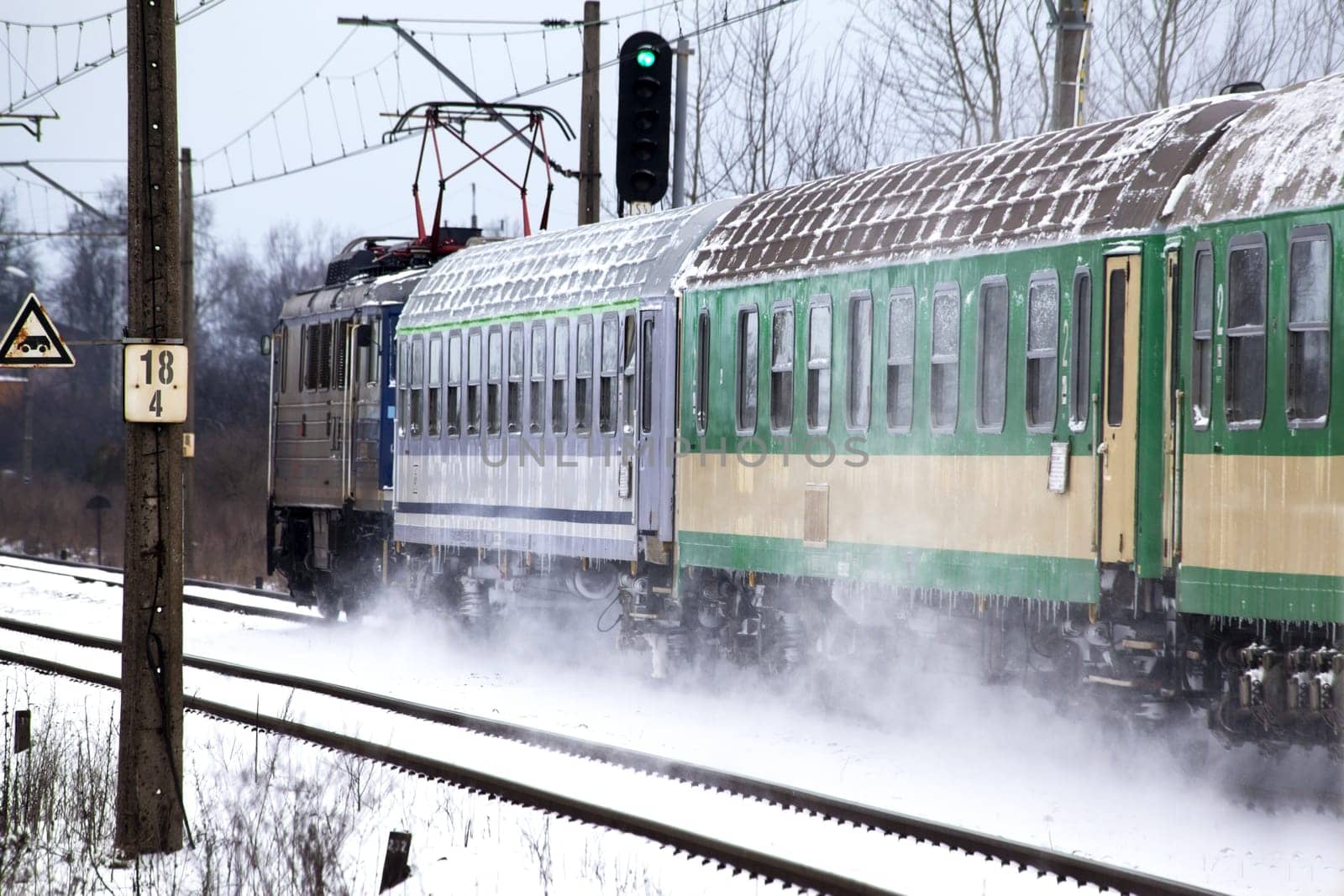 Passenger train passes the snowy line during wintertime in Poland