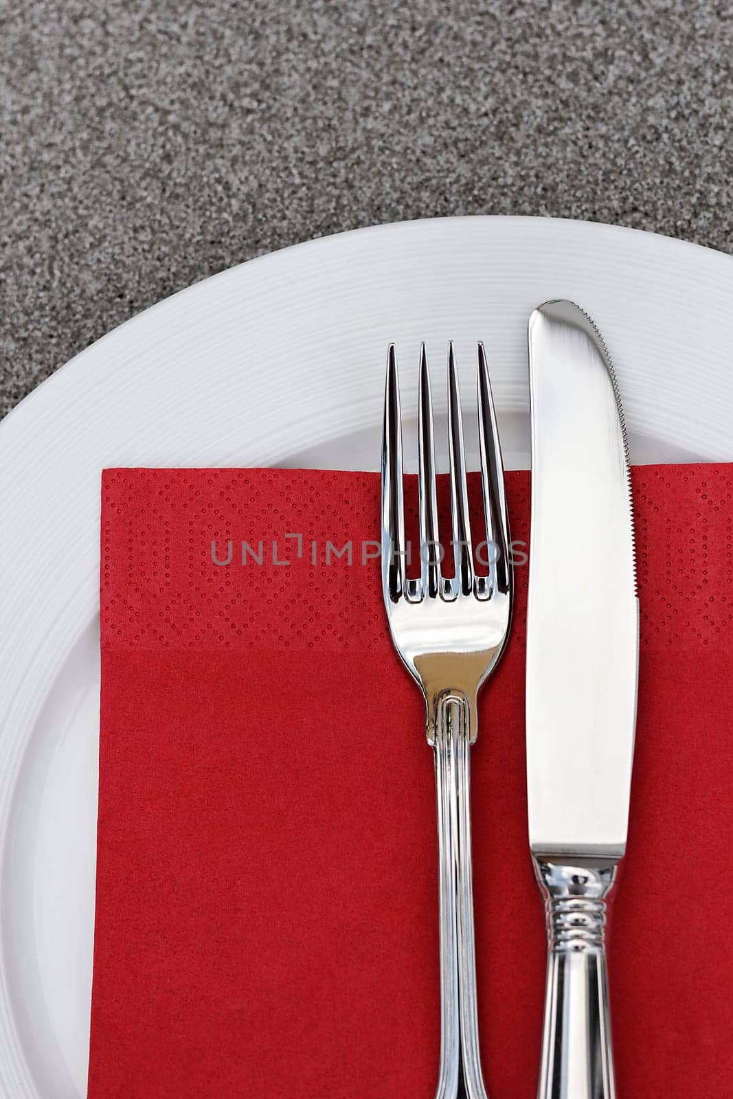 Plate with cutlery and red napkin