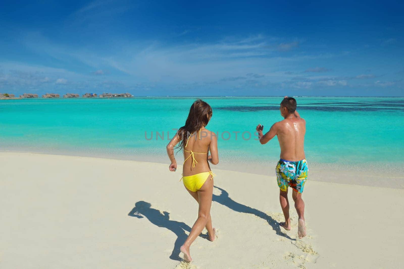 happy young asian couple have fun and romantic time at  summer on beautiful white sand beach