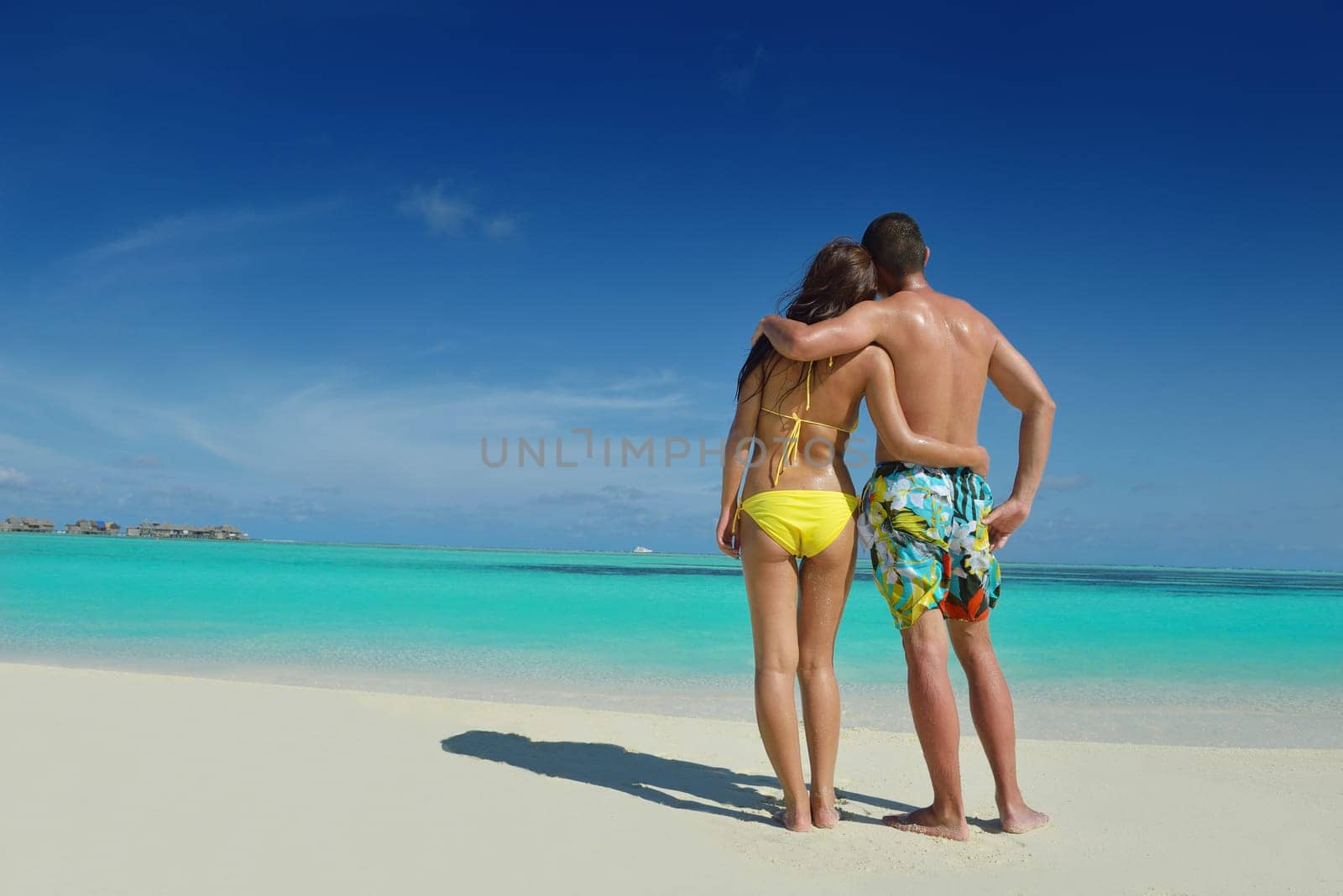 happy young asian couple have fun and romantic time at  summer on beautiful white sand beach