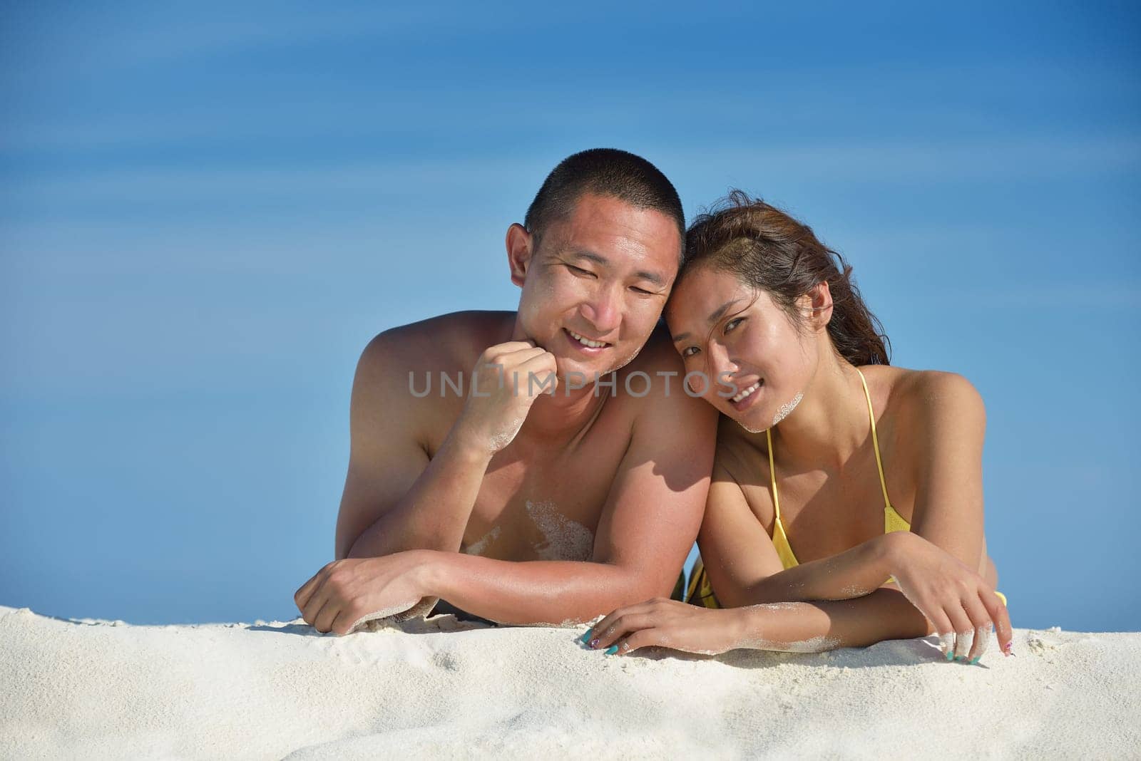 happy young asian couple have fun and romantic time at  summer on beautiful white sand beach