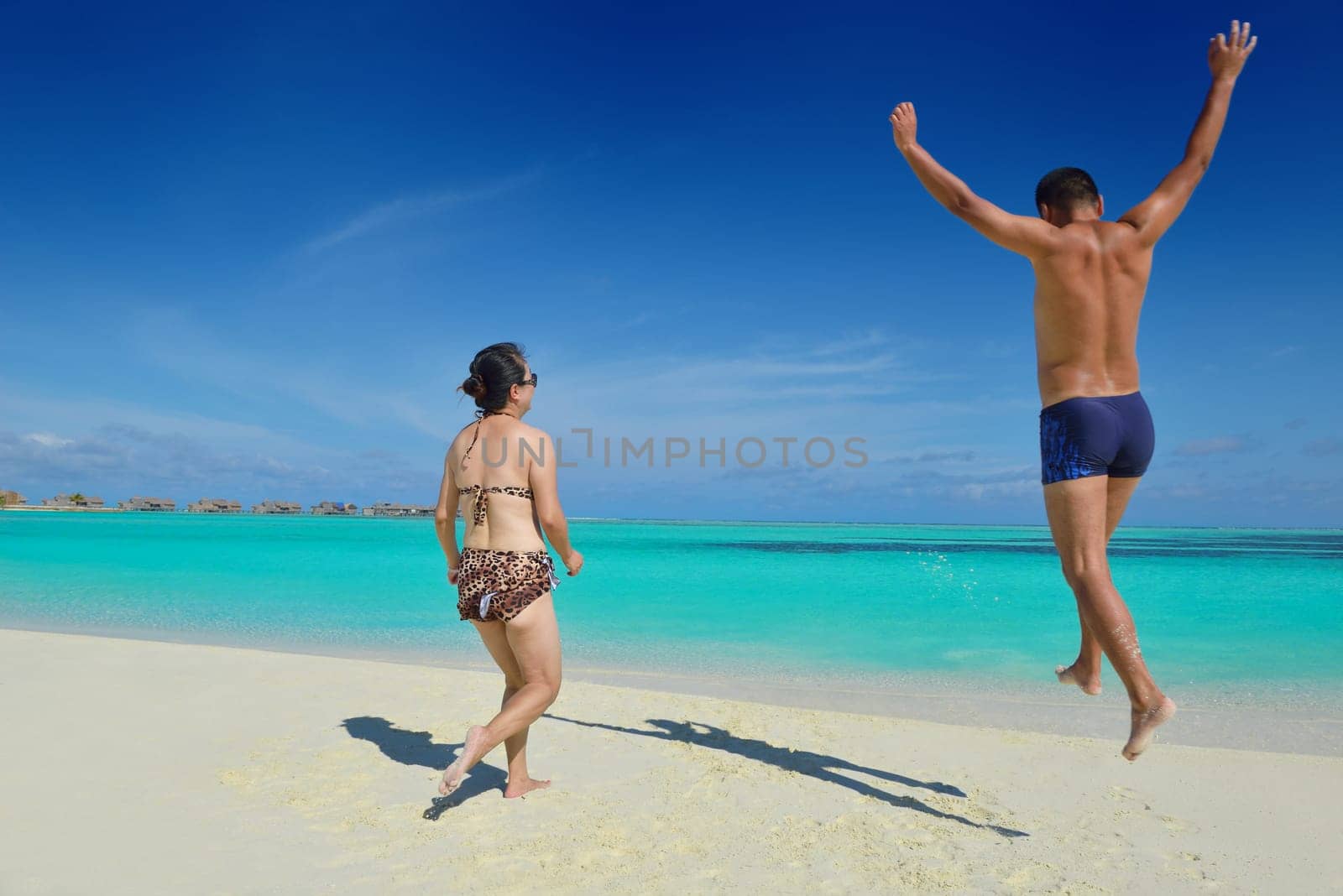 happy young asian couple have fun and romantic time at  summer on beautiful white sand beach