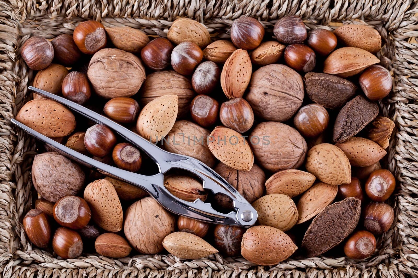 Christmas whole nuts in a basket with a nutcracker
