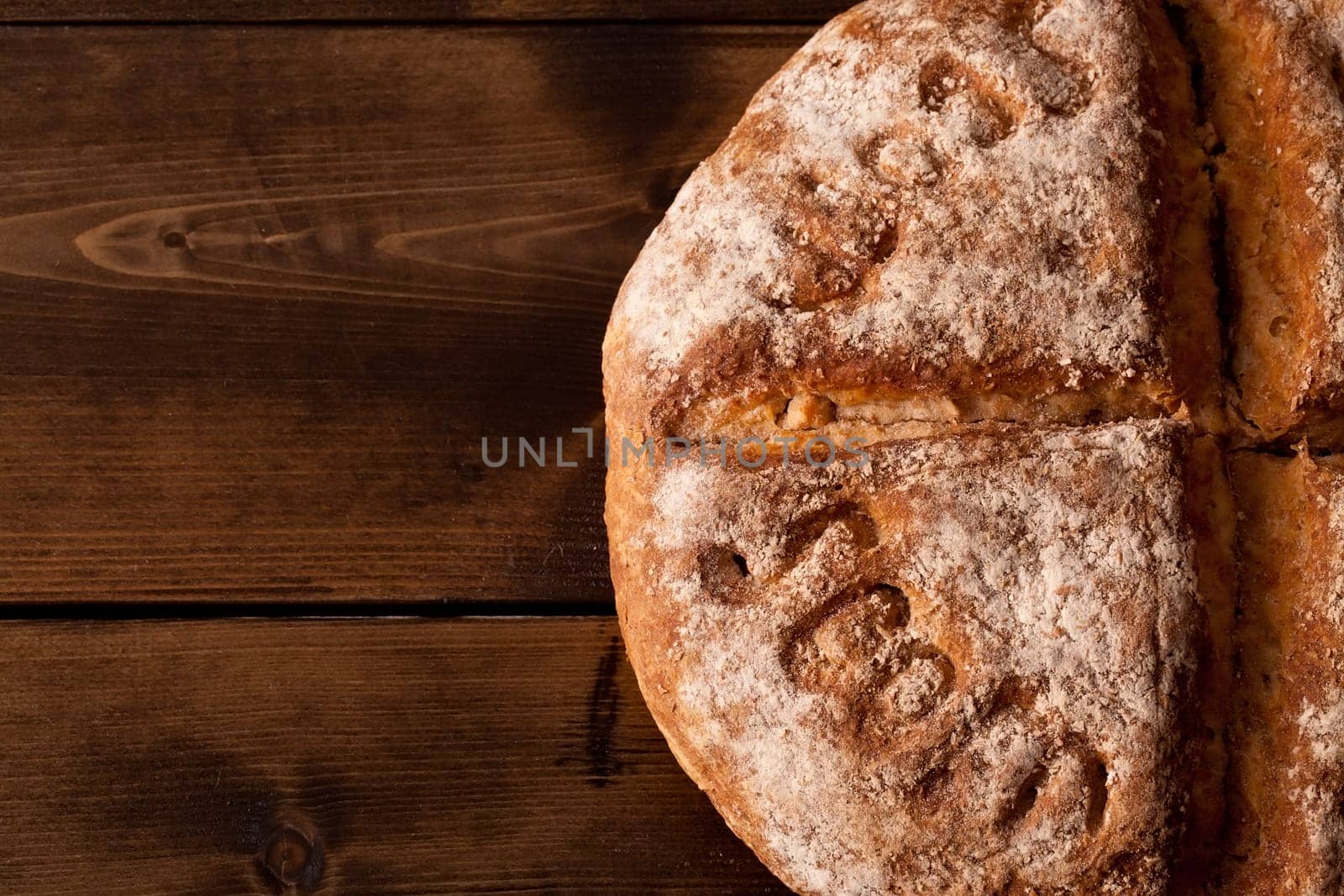 Rustic bread close up on a wooden table