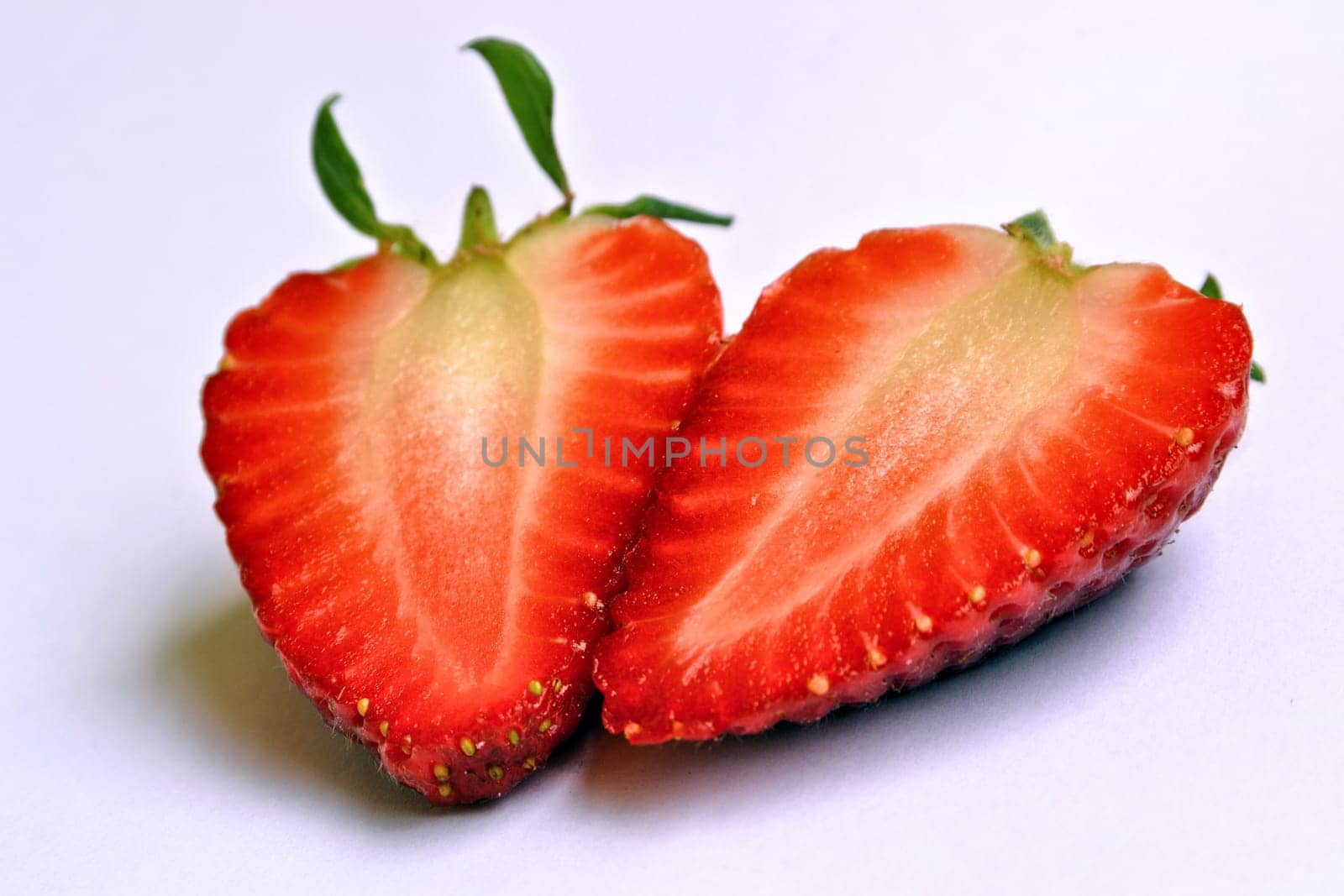 Divided strawberry with a white background