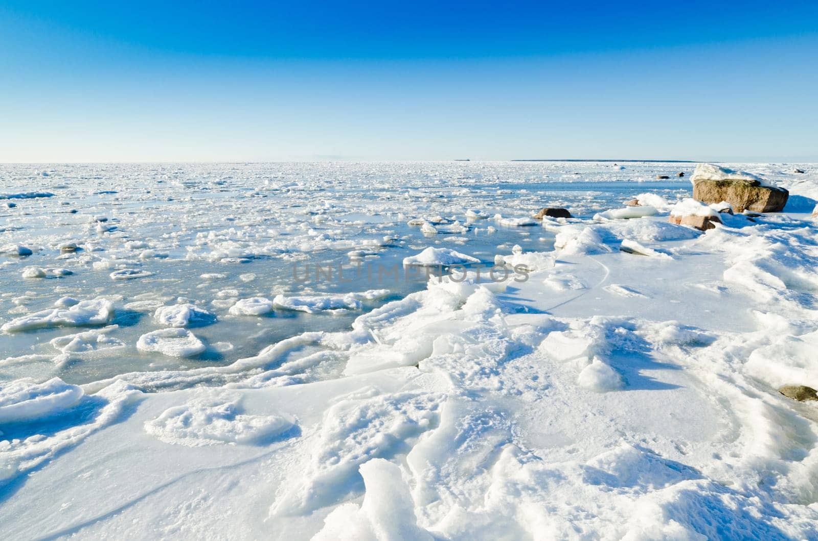 The coast of Baltic sea held down by an ice