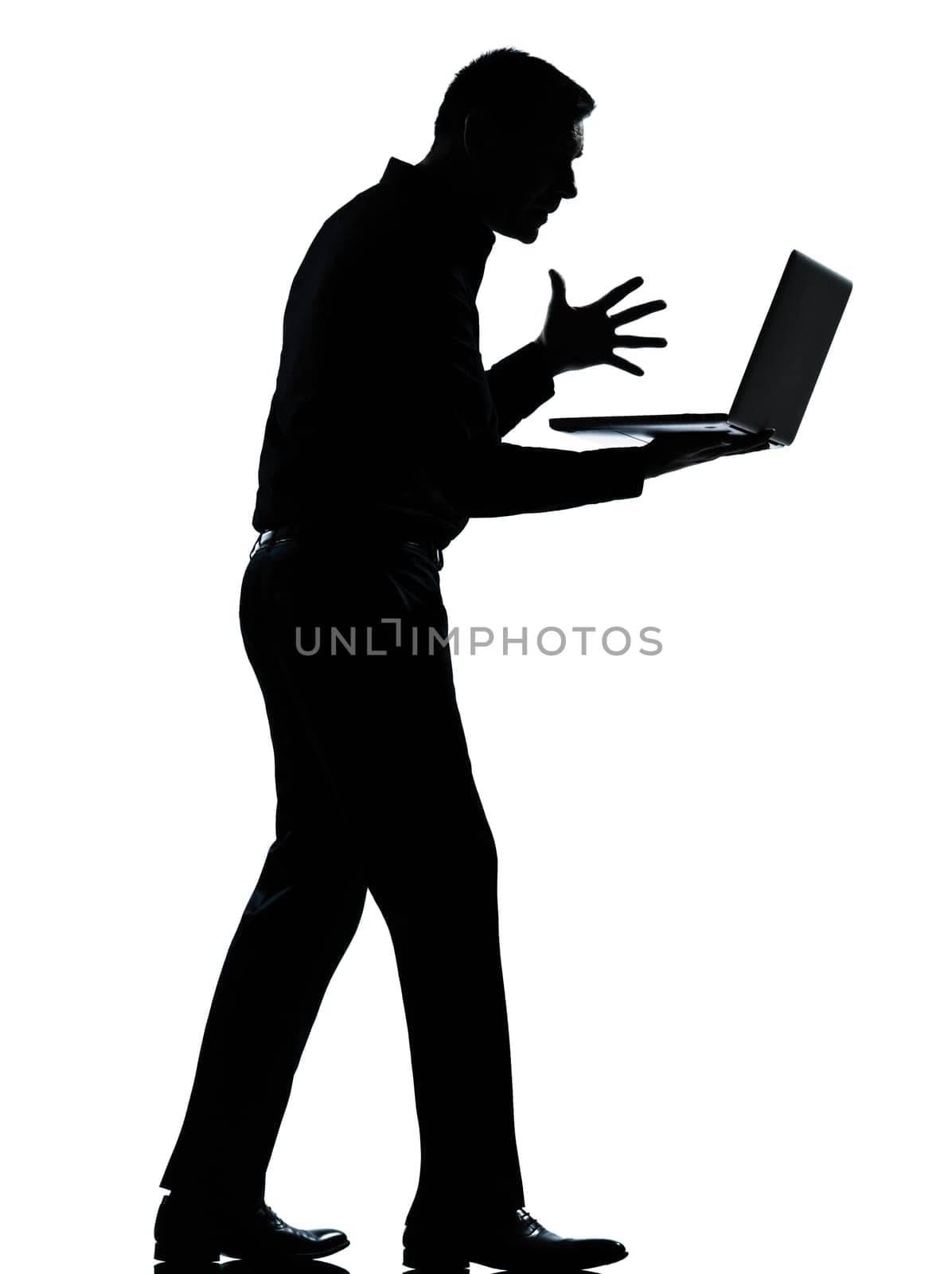 one caucasian business man computing computer laptop angry displeased silhouette standing Full length in studio isolated on white background