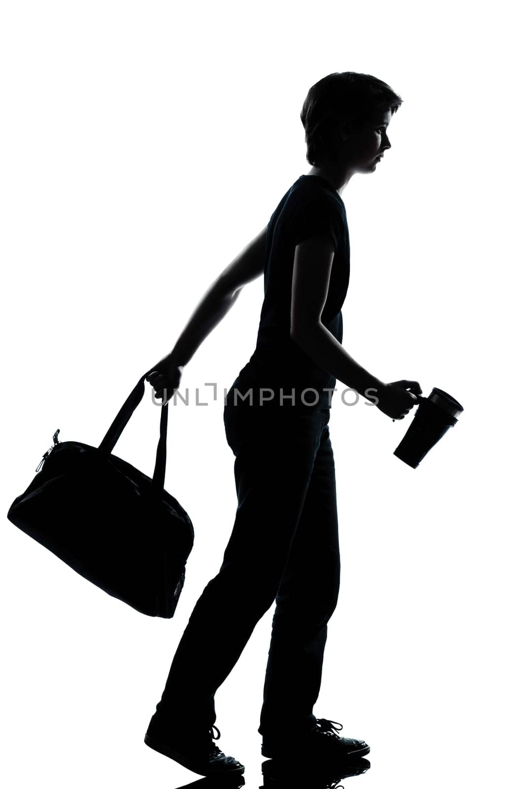 one caucasian young teenager silhouette school boy or girl walking full length in studio cut out isolated on white background
