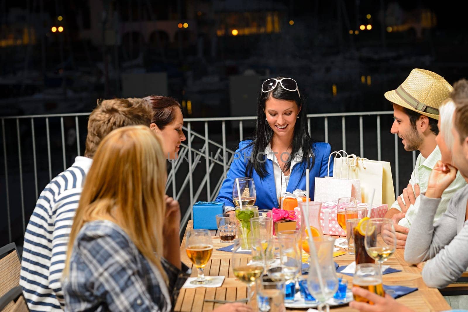 Young friends celebrating outdoors birthday party marina terrace restaurant