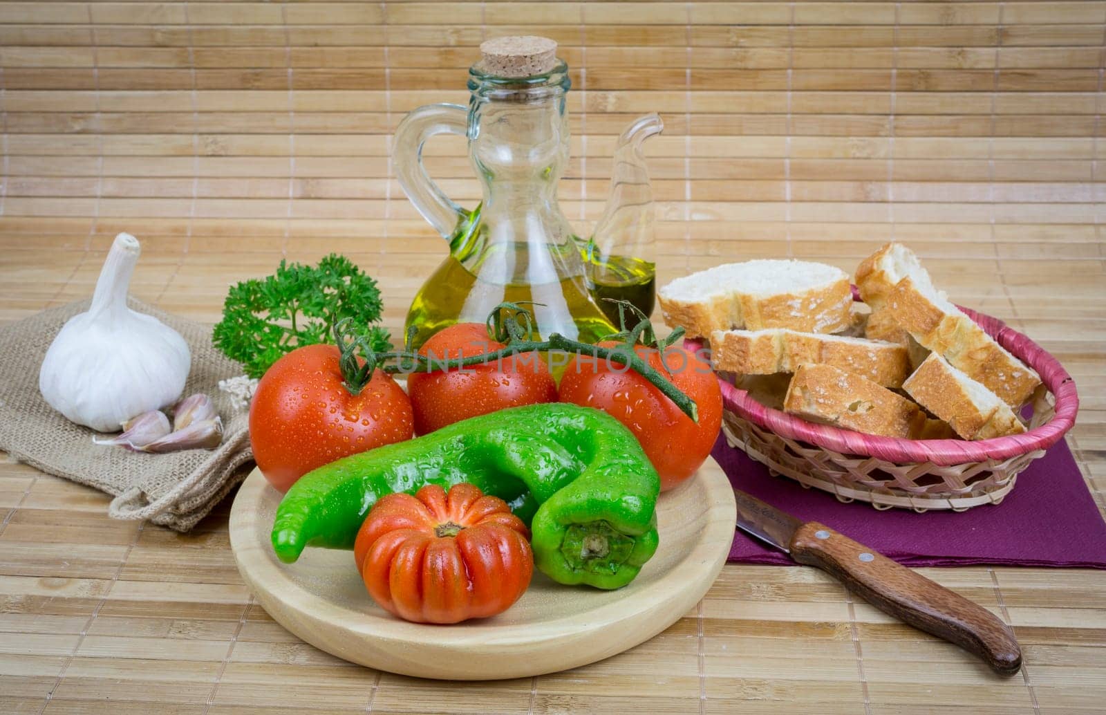 olive oil with garlic and onions on wooden board