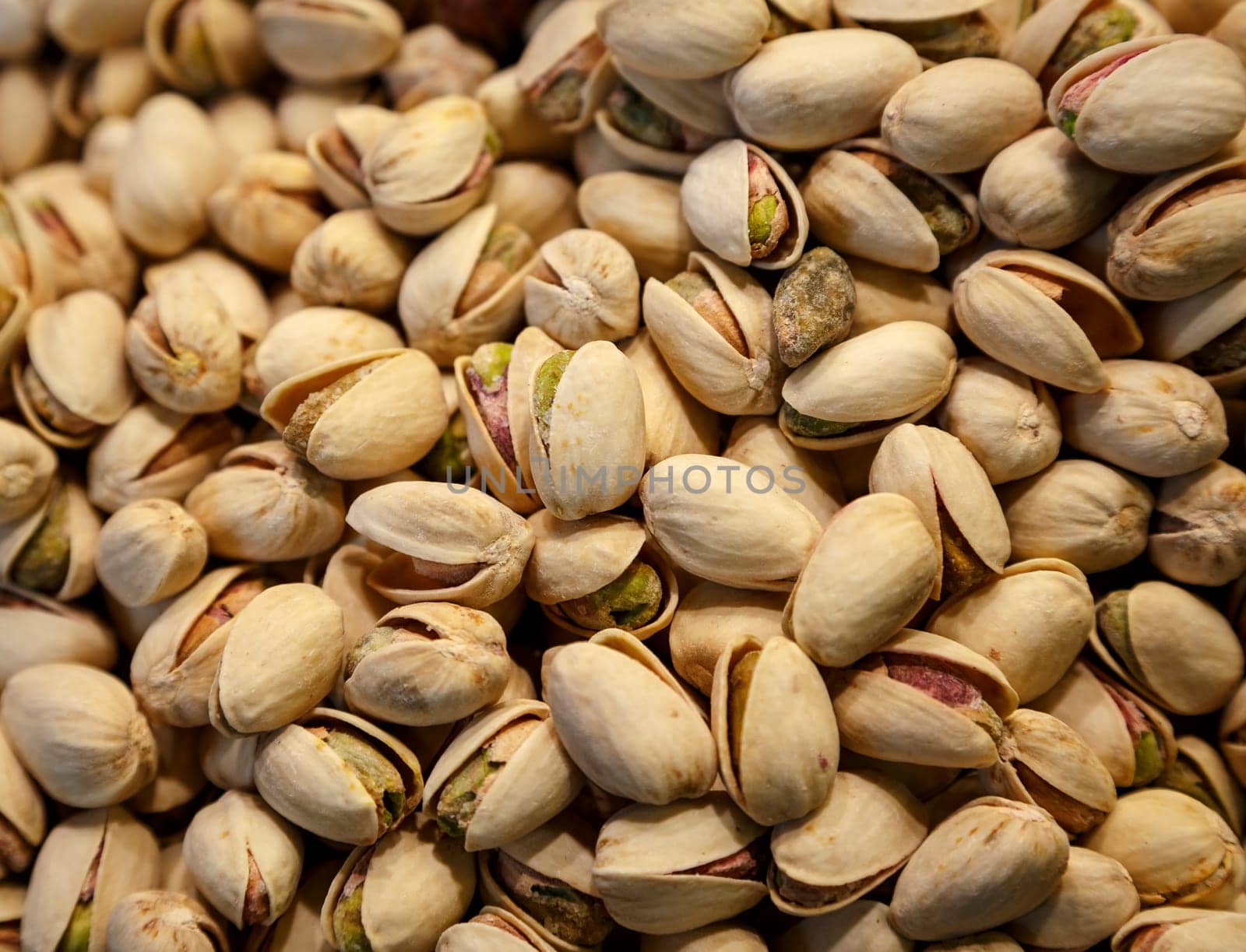 closeup image of a pile of pistachios