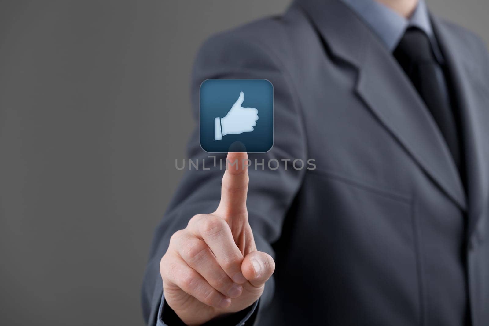 Social media concept. Businessman click on the like button.