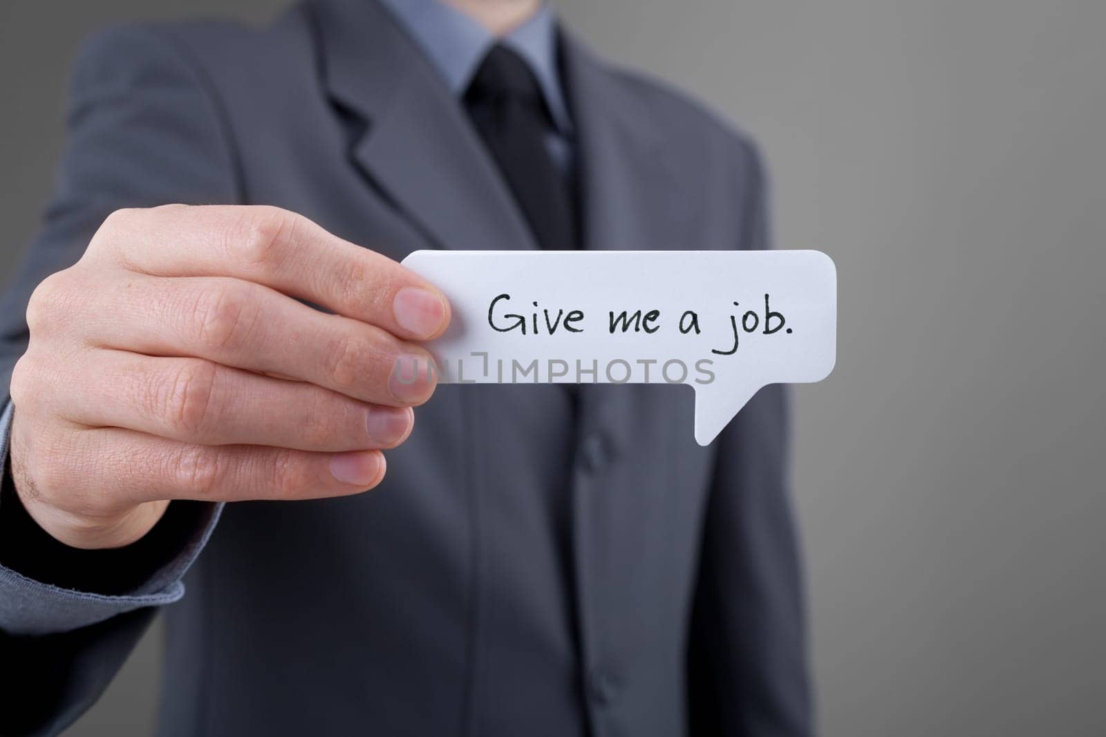 Young businessman hold comics bubble with text Give me a job. Unemployed person (jobless, out of work) concept.