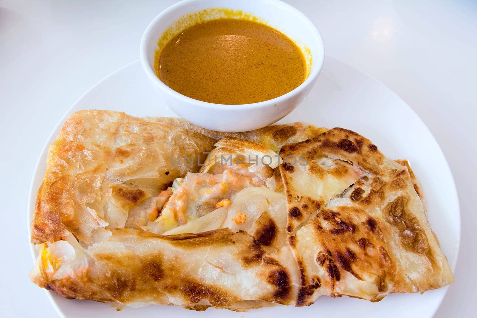Indian Roti Prata with Chicken Meat and Curry Sauce