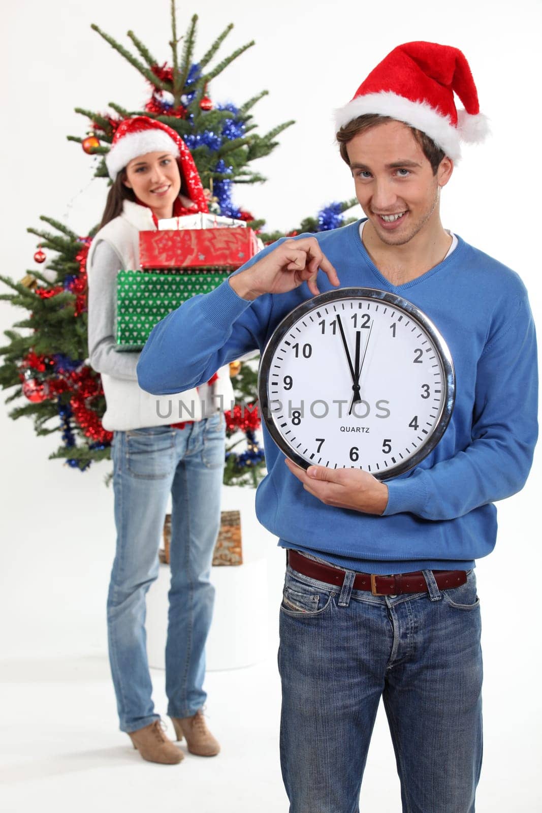 Couple eagerly waiting for Christmas Day to open presents