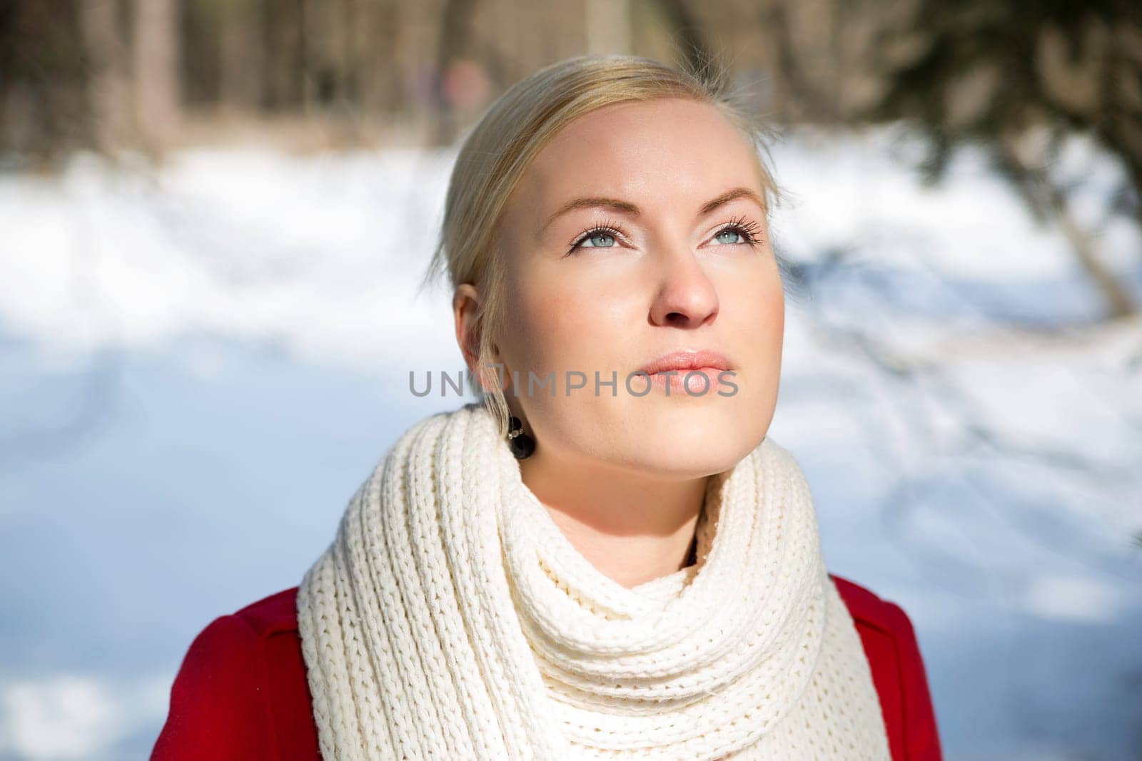 Zoomed woman warming face under sunlight at winter